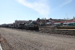 NS 7593 and 7637 take a train of flat cars east